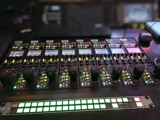 Operator running a multi-camera live stream from a broadcast switcher in a modern Bali studio