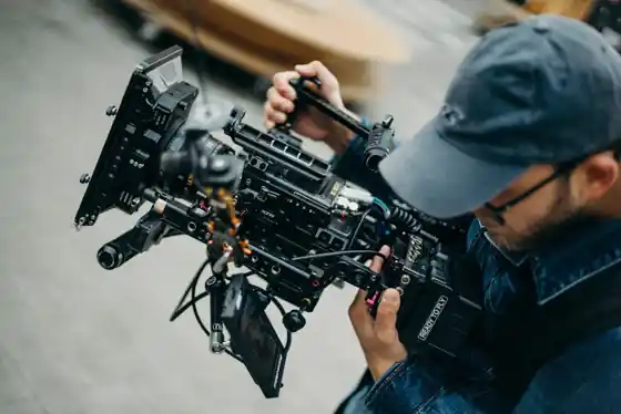 Cinematographer operating a professional cinema camera on a shoulder rig